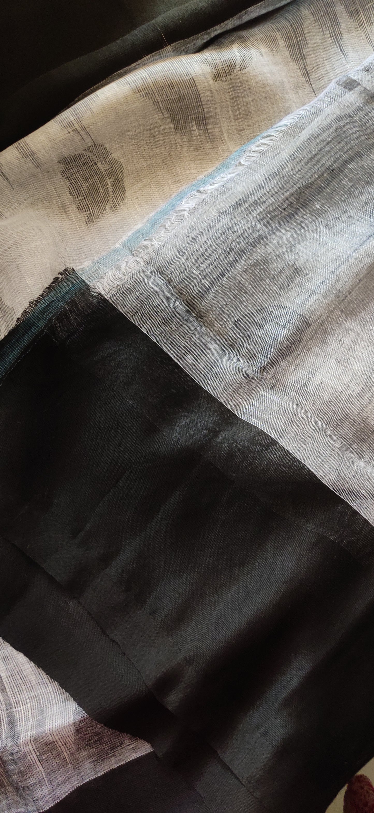 White Linen Ikkat blended zari worked black border done Saree